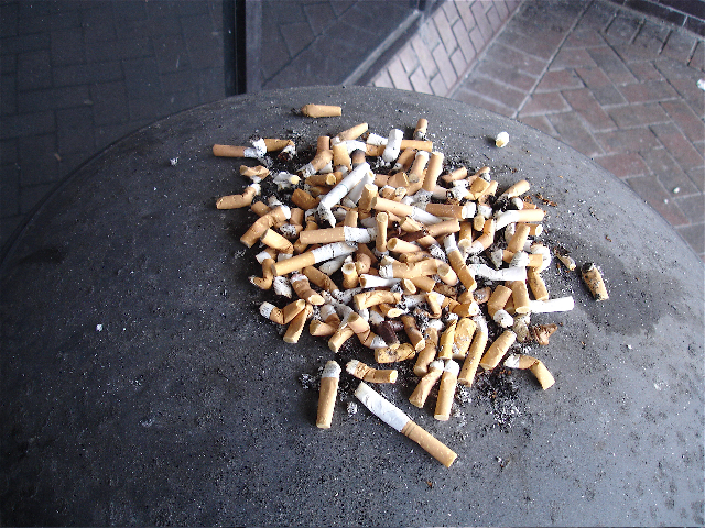 cigarette butts overflowing outside airport stop smoking with hypnotherapy
